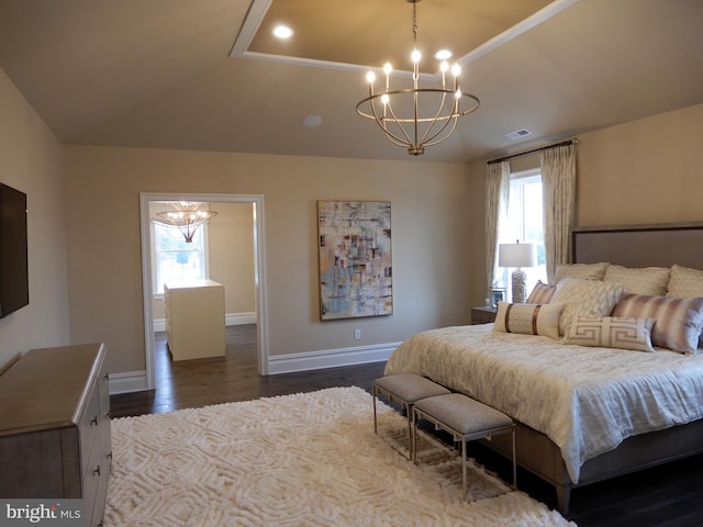 bedroom with a chandelier, dark wood-type flooring, and multiple windows