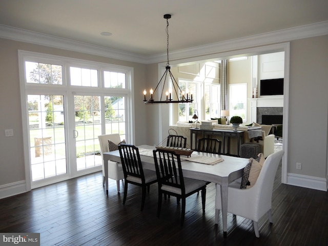 dining space featuring a chandelier, dark hardwood / wood-style flooring, and ornamental molding