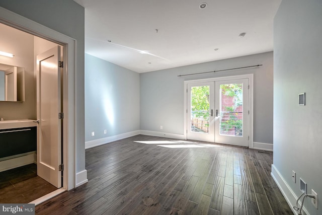 unfurnished room with french doors and dark hardwood / wood-style flooring