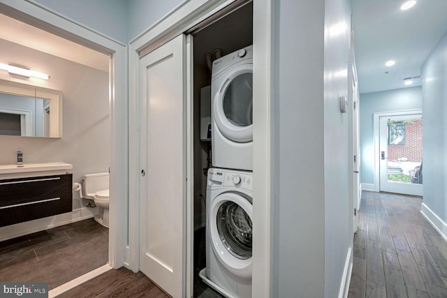 clothes washing area with stacked washer / drying machine