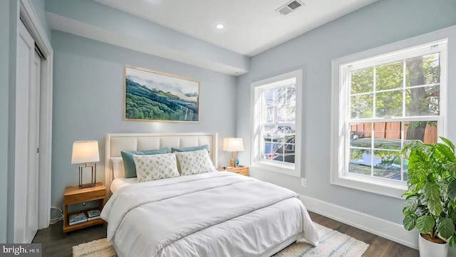 bedroom featuring dark hardwood / wood-style flooring and a closet