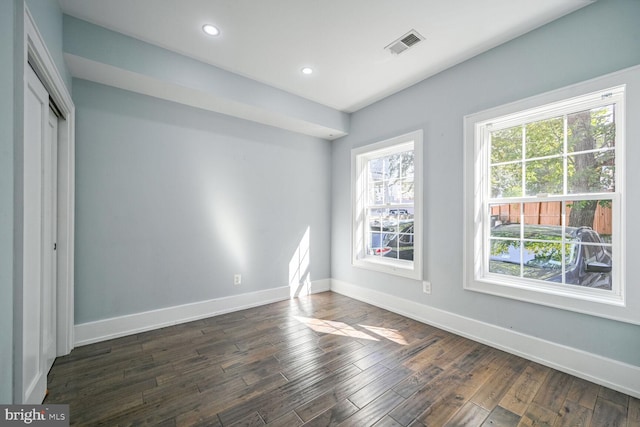 empty room with dark hardwood / wood-style floors