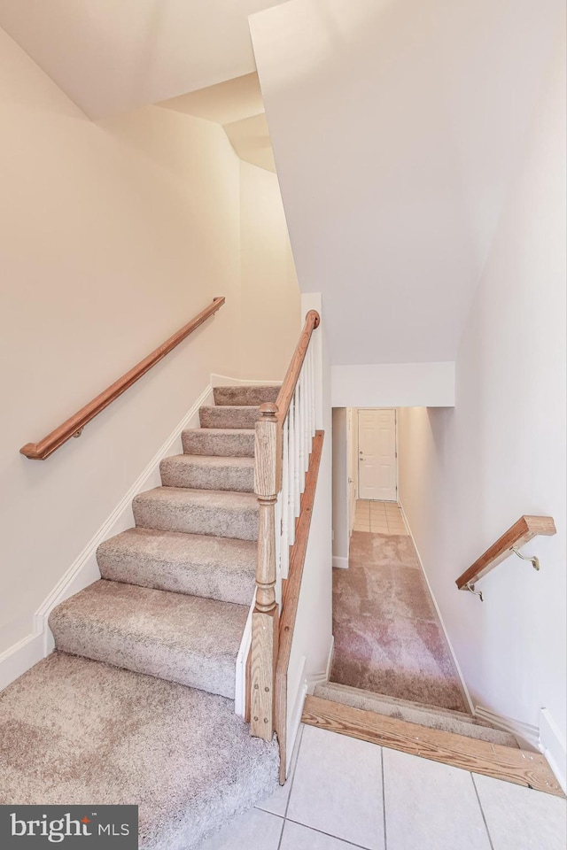 stairway with tile patterned flooring