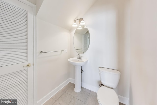 bathroom with tile patterned flooring and toilet