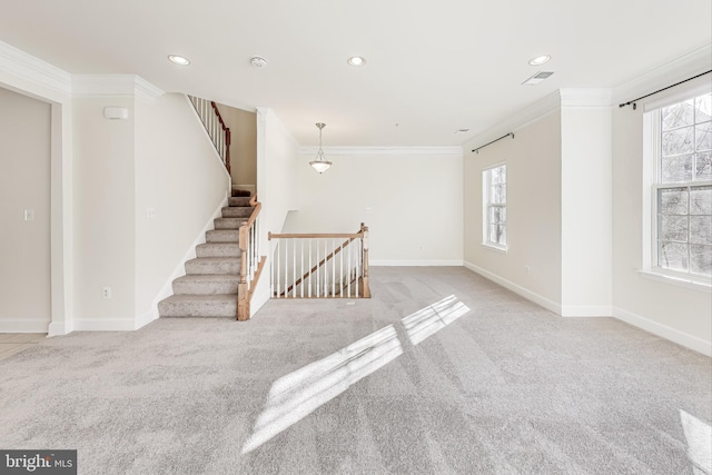 interior space with light colored carpet and crown molding