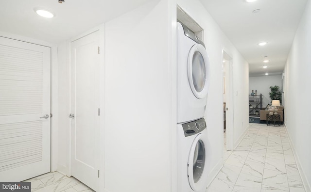 clothes washing area with stacked washer and dryer