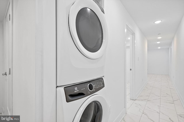 washroom with stacked washer / drying machine