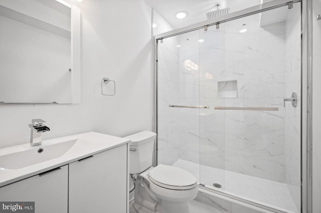 bathroom with vanity, toilet, and an enclosed shower