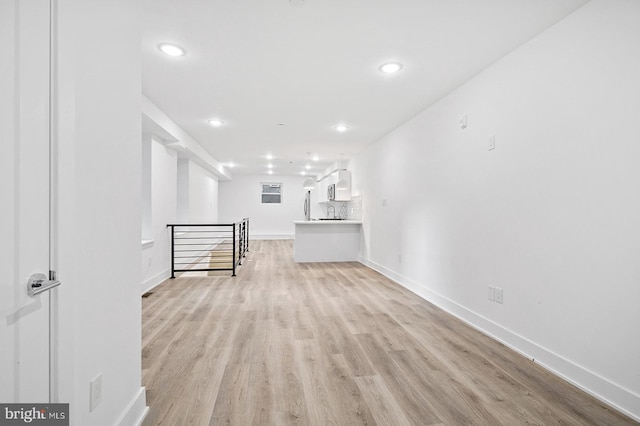 unfurnished living room with light hardwood / wood-style flooring