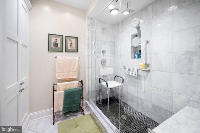 bathroom featuring a shower with shower door