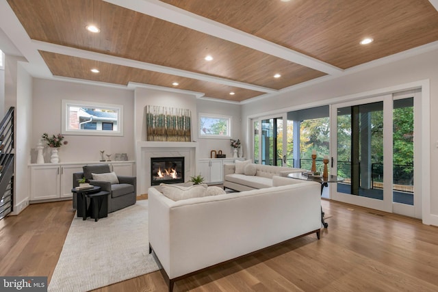 living room featuring beamed ceiling, light wood-type flooring, wood ceiling, and a high end fireplace