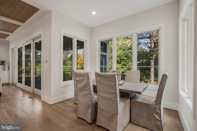 dining space featuring light hardwood / wood-style flooring and french doors