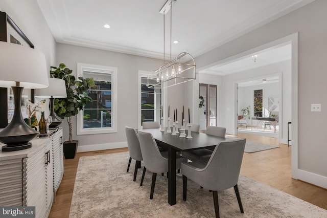 dining room featuring plenty of natural light, an inviting chandelier, and light hardwood / wood-style flooring