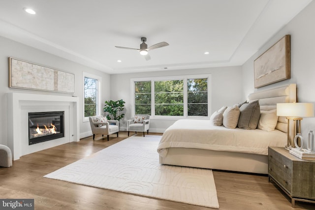 bedroom with ceiling fan and light hardwood / wood-style flooring