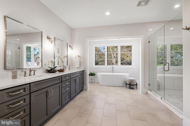 bathroom featuring tile patterned floors, vanity, and separate shower and tub