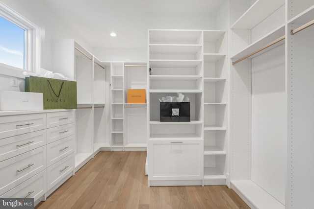 walk in closet with light wood-type flooring