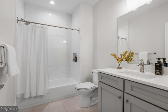 full bathroom with tile patterned floors, vanity, shower / bath combo, and toilet