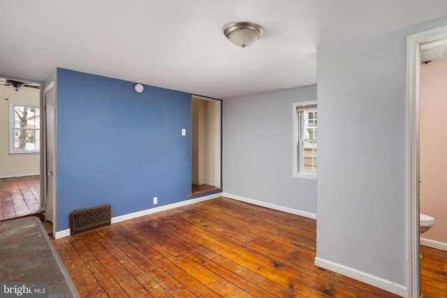 empty room featuring ceiling fan and dark hardwood / wood-style flooring