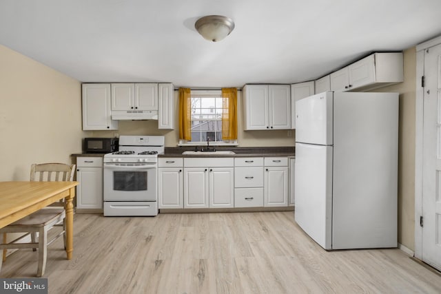 kitchen featuring light wood-type flooring, white appliances, white cabinetry, and sink