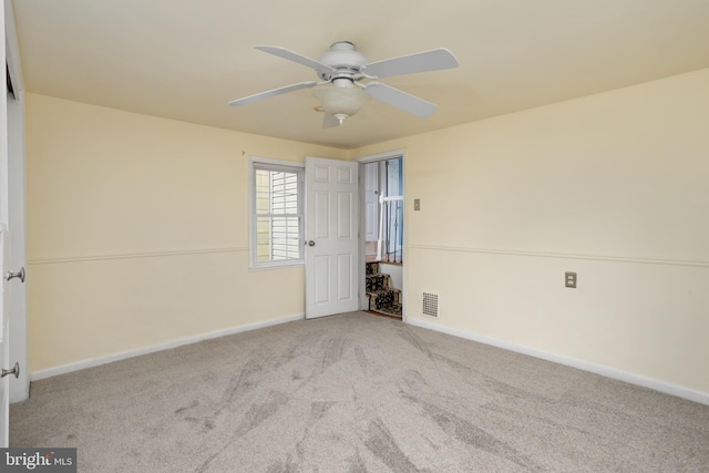 unfurnished room featuring light carpet and ceiling fan