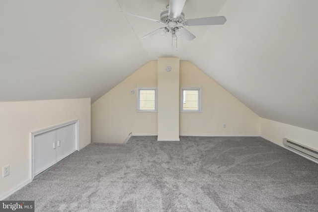 additional living space featuring ceiling fan, light colored carpet, a baseboard radiator, and vaulted ceiling