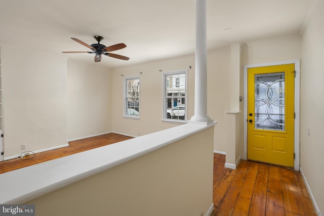 entrance foyer with ceiling fan and dark wood-type flooring