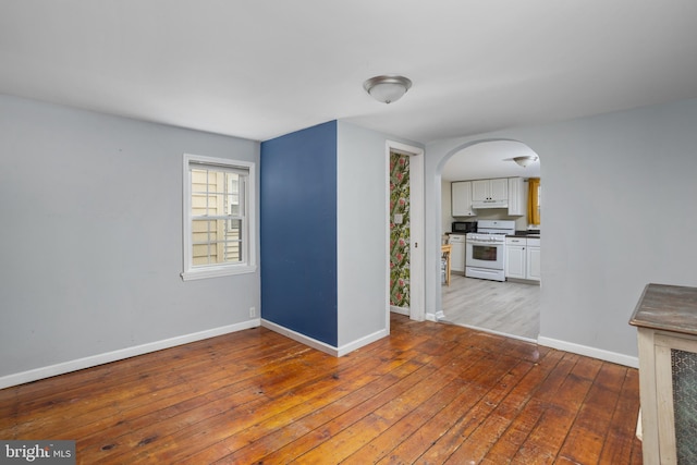 unfurnished room with hardwood / wood-style floors