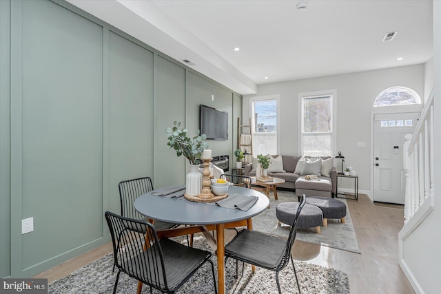 dining space with plenty of natural light and light wood-type flooring