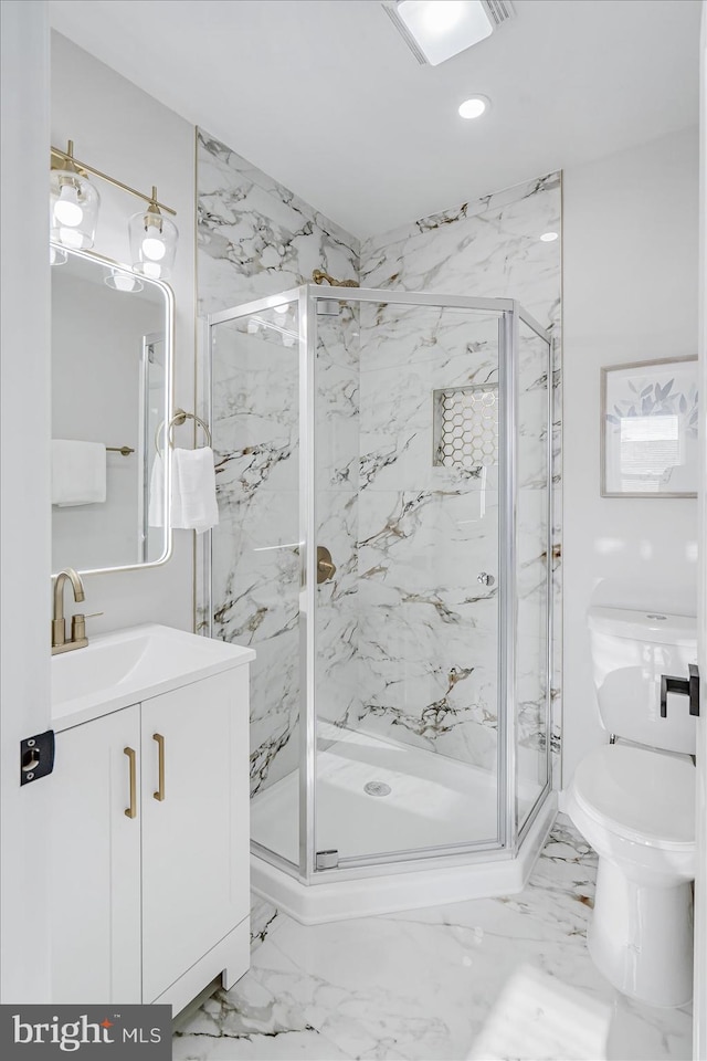 bathroom with vanity, toilet, and an enclosed shower