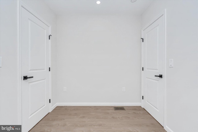 empty room with light hardwood / wood-style flooring