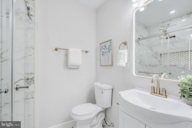 bathroom featuring vanity, toilet, and an enclosed shower