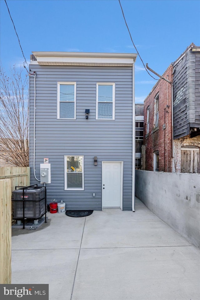 back of house featuring central AC unit