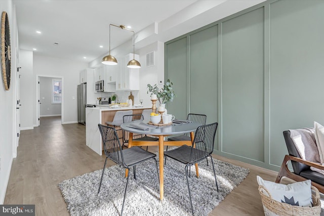 dining space featuring light wood-type flooring