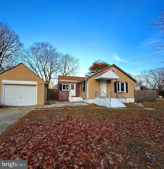 single story home with an outbuilding and a garage