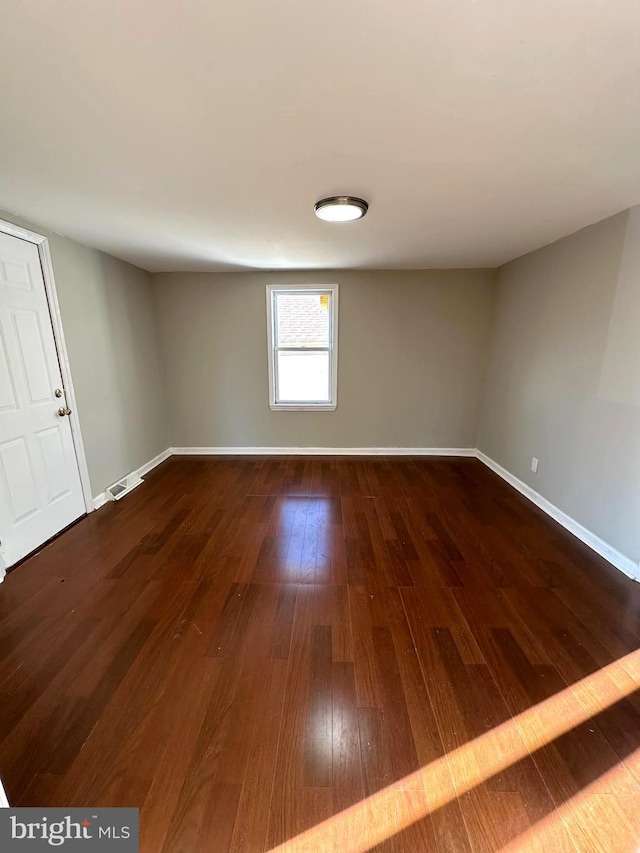 empty room featuring dark hardwood / wood-style flooring