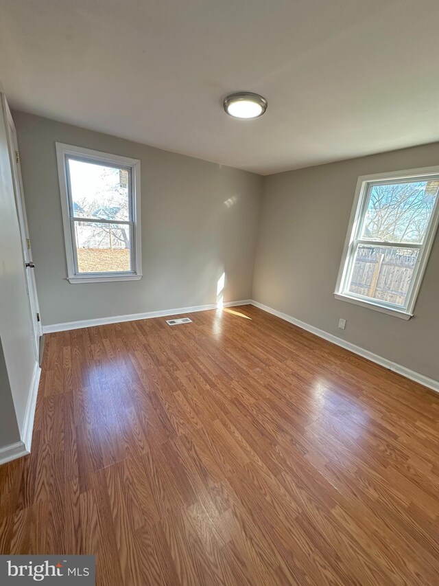 empty room with hardwood / wood-style floors