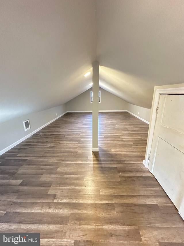 bonus room featuring dark hardwood / wood-style floors and lofted ceiling