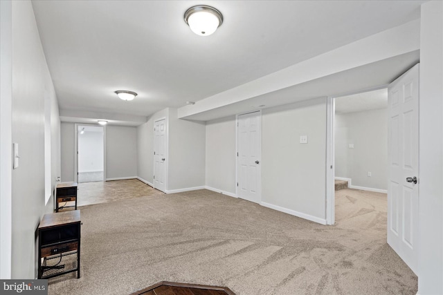 basement featuring light carpet