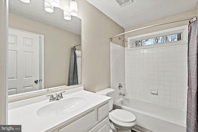 full bathroom with vanity, toilet, shower / bathtub combination with curtain, and a textured ceiling