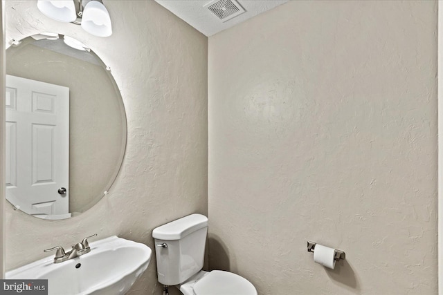 bathroom featuring toilet and sink