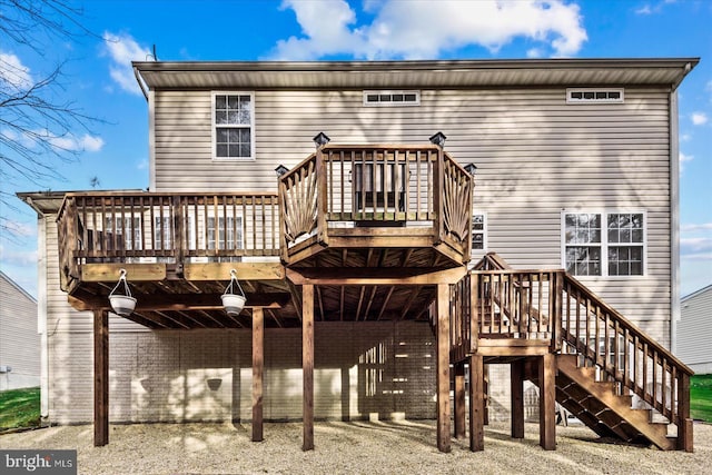 rear view of house featuring a wooden deck