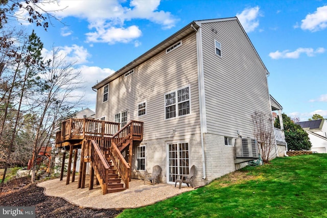 back of property with a deck, cooling unit, and a lawn