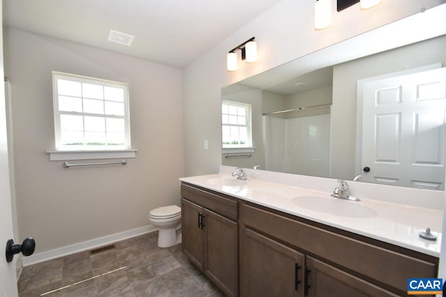 bathroom with vanity, toilet, and walk in shower