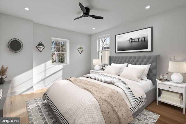 bedroom featuring ceiling fan, baseboards, wood finished floors, and recessed lighting