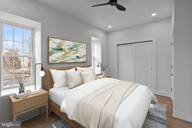 bedroom with recessed lighting, a closet, ceiling fan, wood finished floors, and baseboards