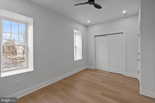 unfurnished bedroom featuring light wood-type flooring, baseboards, and recessed lighting