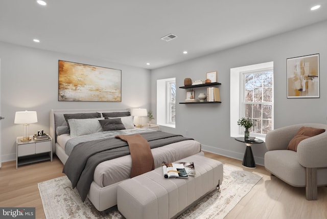 bedroom featuring baseboards, light wood-style flooring, visible vents, and recessed lighting