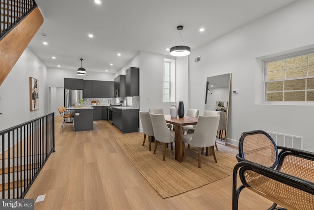 dining room featuring light wood-style flooring, visible vents, and recessed lighting