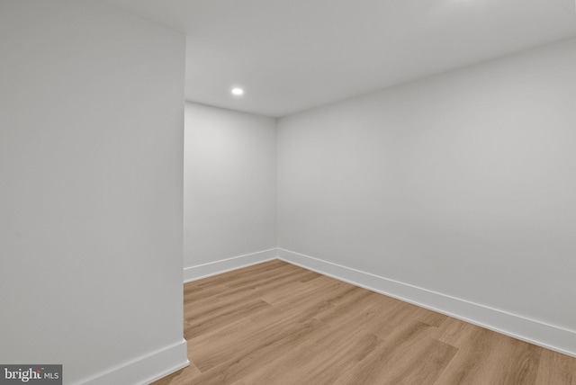 empty room with light wood-style floors, recessed lighting, and baseboards