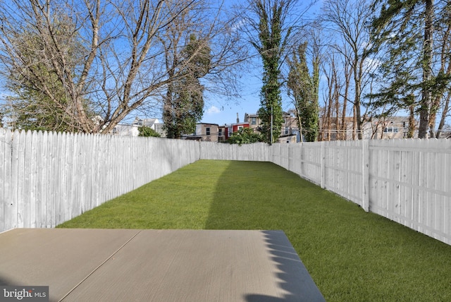 view of yard with a fenced backyard